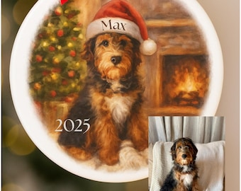 May include: A round, white ceramic ornament with a painted portrait of a dog wearing a Santa hat. The ornament has a red bow and the text "We turn your favorite pet pic into a classic holiday treasure". The dog's name, "Max", is on the hat, and the year "2025" is below the dog.