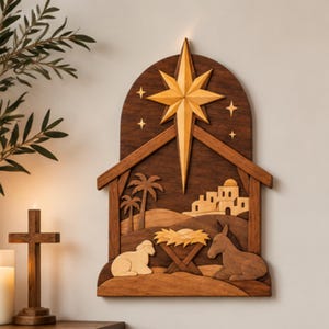 May include: A wall-mounted wooden nativity scene plaque featuring a large central star, a manger, a sheep, a donkey, palm trees, and a distant building. The artwork is crafted from layered wood in varying shades of brown, creating a dimensional effect.