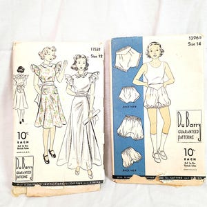 May include: Two vintage Du Barry sewing pattern envelopes. The left envelope, 1753B size 12, shows illustrations of dresses with ruffled sleeves. The right envelope, 1396B size 14, displays illustrations of a tank top and bloomers with back views.