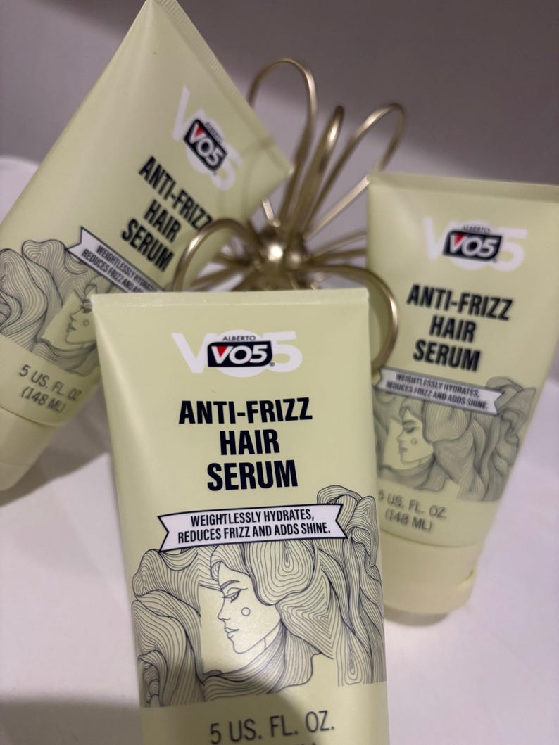 May include: Several tubes of Alberto VO5 Anti-Frizz Hair Serum are displayed. The tubes are light yellow with black and white text and a drawing of a woman's profile. Each tube contains 148 ml of serum.