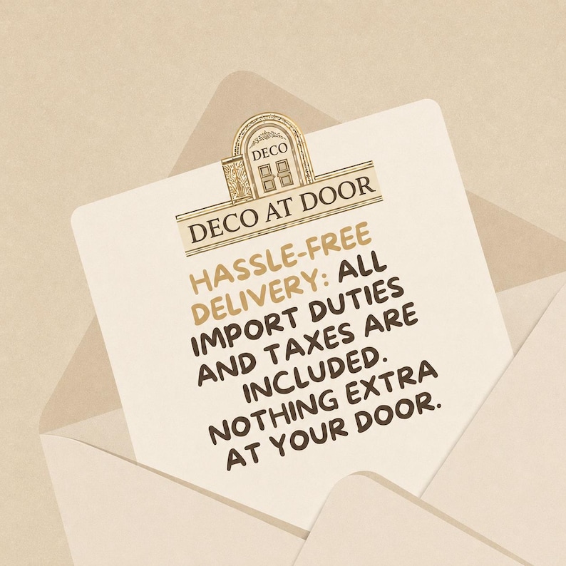 May include: A cream-colored envelope containing a card with the gold and brown logo DECO AT DOOR. The text reads: HASSLE-FREE DELIVERY: ALL IMPORT DUTIES AND TAXES ARE INCLUDED. NOTHING EXTRA AT YOUR DOOR. The design features an arched doorway icon.