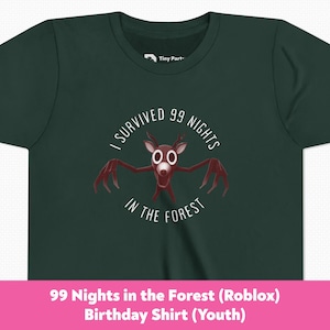 May include: Dark green youth t-shirt with a circular graphic featuring a cartoon deer-like creature with long claws and the text "I SURVIVED 99 NIGHTS IN THE FOREST". The shirt has a crew neck and short sleeves.