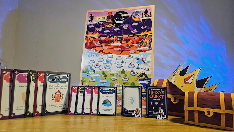 May include: A board game setup featuring a colorful game board with various illustrated locations. The game includes cards, miniature figures, a treasure chest, and a golden crown. The game is titled "The Ultimate Hero's Quest".