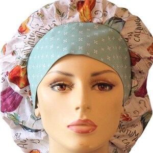May include: A white and blue patterned surgical scrub hat with a light blue band. The hat features a floral design with the text "Autumn is Calling" and "Fall into Joy".