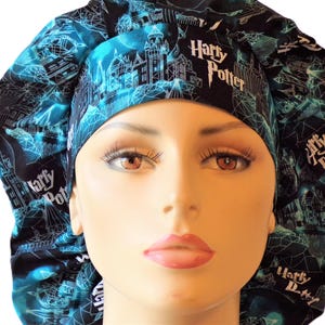 May include: A black and teal bouffant surgical scrub cap featuring a repeating pattern of a castle and geometric shapes. The words "Harry Potter" are printed on the front of the cap in white. The cap is designed to cover the hair.