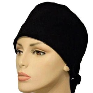 May include: A black scrub cap with a tie at the back. The cap is made of a soft, comfortable fabric and is designed to keep hair out of the way.