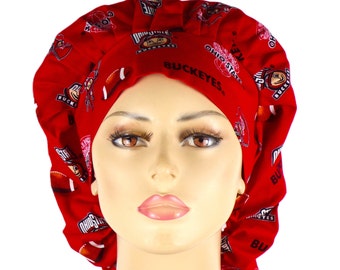 May include: Red surgical scrub hat with a repeating pattern of Ohio State Buckeyes logos, footballs, and the words "Ohio State Buckeyes".