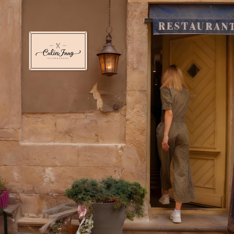 May include: Exterior shot of a restaurant entrance. A sign with the text "Culin Fang" hangs on the wall. A vintage lantern is suspended above a potted plant. A person in a green jumpsuit enters the restaurant.