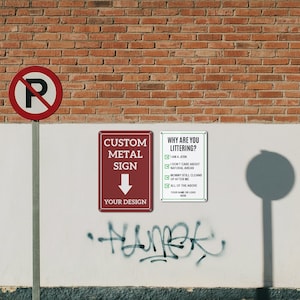 May include: A street scene featuring a red and white "No Parking" sign, a custom metal sign, and a sign asking "Why Are You Littering?" against a brick and white wall. The custom sign is burgundy with white text and a downward arrow. The littering sign has green text.