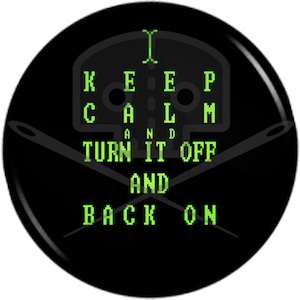 May include: Black button with green text that reads "Keep Calm and Turn It Off and Back On". The text is in a pixelated font. Two crossed sewing needles are behind the text.