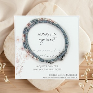 Peut inclure: Une tasse en céramique blanche avec une anse noire et le texte "But First, Coffee" en noir, dans une police manuscrite. La tasse est posée sur une surface blanche.