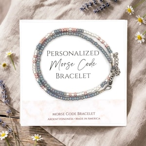 May include: A set of three ceramic mugs with a speckled, matte finish. The mugs are in shades of cream, light gray, and dark gray. Each mug has a simple, minimalist design and a rounded handle.