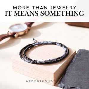 May include: A double-wrap beaded bracelet featuring alternating matte black and metallic grey beads. The text MORE THAN JEWELRY IT MEANS SOMETHING is displayed at the top, and ARDENTFONDNESS is printed at the bottom of the image.