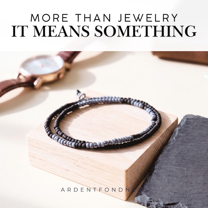 May include: A double-wrap beaded bracelet featuring alternating matte black and metallic grey beads. The text MORE THAN JEWELRY IT MEANS SOMETHING is displayed at the top, and ARDENTFONDNESS is printed at the bottom of the image.