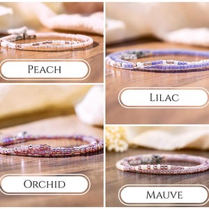 May include: A collection of four delicate beaded bracelets in peach, lilac, orchid, and mauve colorways. Each bracelet features small, uniform glass beads in tonal shades with metallic accents and a silver-toned metal clasp closure.