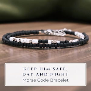 May include: A white ceramic mug with a black handle and the text "But First, Coffee" in a black, bold font. The mug is sitting on a white surface.