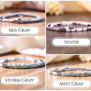 May include: Four thin beaded bracelets arranged in a grid, each featuring a unique color palette. The labels identify them as Iris Gray, Silver, Storm Gray, and Mist Gray. Each bracelet is composed of small, round, reflective glass beads in shades of gray, white, and metallic silver, creating a delicate and uniform circular design.