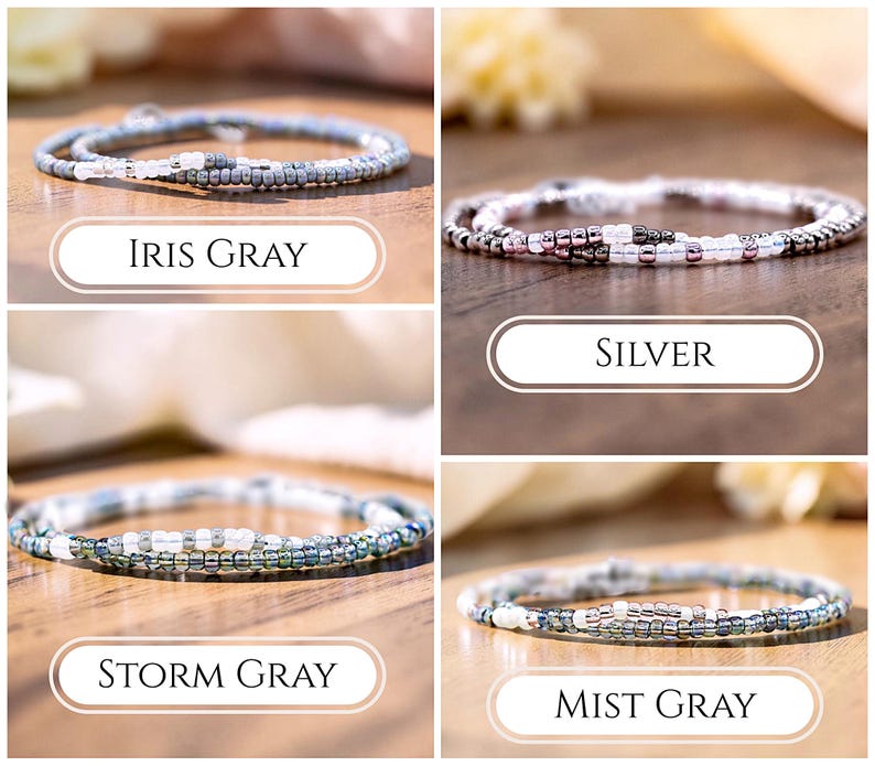 May include: Four thin beaded bracelets arranged in a grid, each featuring a unique color palette. The labels identify them as Iris Gray, Silver, Storm Gray, and Mist Gray. Each bracelet is composed of small, round, reflective glass beads in shades of gray, white, and metallic silver, creating a delicate and uniform circular design.