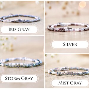 May include: Four beaded wrap bracelets in various colors: Iris Gray, Silver, Storm Gray, and Mist Gray. Each bracelet is made of small, colorful beads and is designed to wrap around the wrist multiple times. The names of the bracelets are displayed below each one.