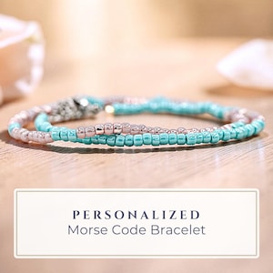 May include: A white ceramic mug with a black handle and the text "But First, Coffee" in a bold, black font. The mug is sitting on a wooden surface. The mug is 4 inches tall.