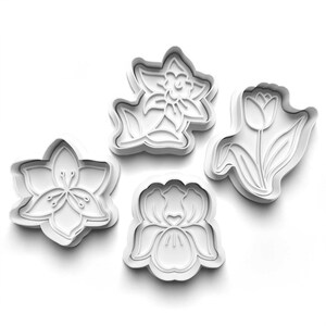 May include: Four white plastic flower-shaped cookie cutters. The cutters include a lily, a daffodil, a tulip, and an orchid. The cutters are designed with detailed floral outlines, perfect for baking spring-themed cookies. The cutters are on a white background.