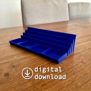May include: A bright blue desk tidy with several compartments and vertical dividers. The organiser is made of a solid material and is designed to hold various items. The image also includes the text "digital download".