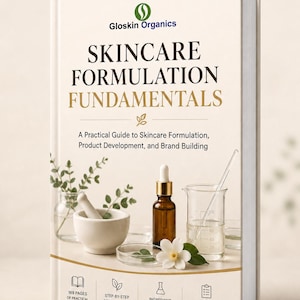 May include: A hardcover book titled Skincare Formulation Fundamentals by Gloskin Organics. The cover features a white background with text, a mortar and pestle, a dropper bottle, a glass beaker, and a white flower. It includes 169 pages of knowledge.