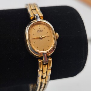 May include: A handcrafted wooden sign, painted white with black lettering, reading "Welcome to our home". The sign has a distressed finish, suitable for hanging indoors or outdoors.