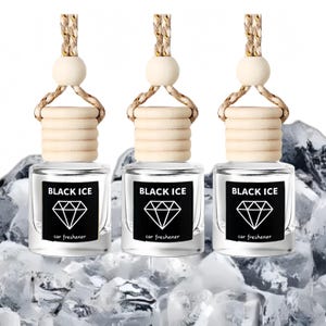 May include: Three car air fresheners with the text "BLACK ICE" on a black label with a diamond graphic. Each bottle has a wooden top and a woven cord for hanging. The background features ice.