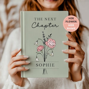 May include: A sage green hardcover journal featuring the text THE NEXT CHAPTER at the top and the name SOPHIE at the bottom. A central illustration depicts a bouquet of black-lined flowers with pink petals and white buds. A pink circular sticker reads HER FLOWER HER NAME.