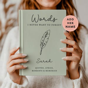 May include: A sage green hardcover journal with black text that reads Words I NEVER WANT TO FORGET, a black line drawing of a feather quill, the name Sarah, and the text QUOTES, LYRICS, MOMENTS & MEMORIES. A pink circular tag says ADD HER NAME.