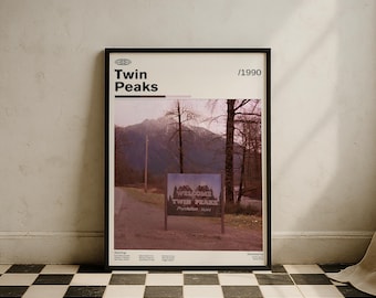 May include: A framed poster with the text "Twin Peaks" and "/1990" at the top. The poster features a landscape image with mountains, trees, and a sign that reads "Welcome to Twin Peaks". The poster is in a black frame.