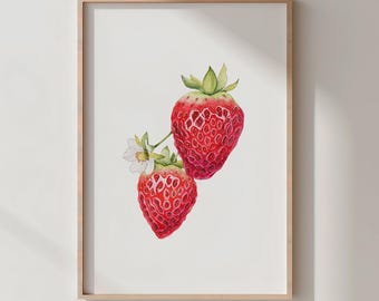 May include: A framed watercolor print featuring two ripe strawberries with green stems and white blossoms. The strawberries are a vibrant red with textured surfaces, set against a white background. The frame is a light brown color.