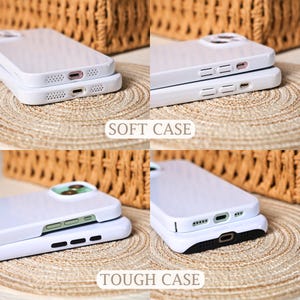 May include: White phone cases, labeled "SOFT CASE" and "TOUGH CASE", are stacked to show the design. The cases have cutouts for the phone's features. The cases are on a woven surface.