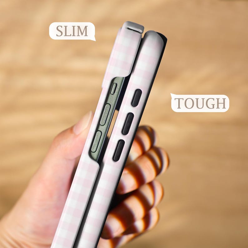 May include: Two phone cases, one partially inserted into the other, are shown in a side view. The cases are light pink with a white gingham pattern. The word "SLIM" is in a white speech bubble. The word "TOUGH" is in a white speech bubble.