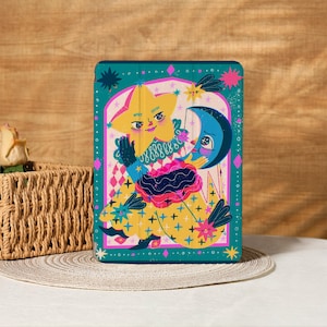 May include: A teal tablet case featuring a whimsical illustration of a yellow star and a blue crescent moon with smiling faces. The design includes a yellow and pink diamond pattern and a floral motif.