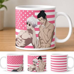 May include: White ceramic mug featuring a pink and white design with illustrations of two shirtless male figures. The mug has a handle and is set against a wooden surface. The design includes pink stars and stripes.