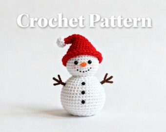 May include: A crocheted snowman wearing a red Santa hat with a white bobble. The snowman has black button eyes, a carrot nose, and a stitched smile. The arms are brown, and the body is white. The text "Crochet Pattern" is above the snowman.