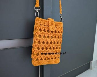 May include: Mustard yellow crochet crossbody bag with an openwork design. The bag features a flap closure with a button and a long strap with silver-tone hardware. The text "myrosecrochet" is visible on the bag.