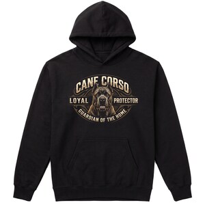 May include: A black hooded sweatshirt featuring a graphic print of a Cane Corso dog head centred within an oval frame. The text reads CANE CORSO, LOYAL PROTECTOR, and GUARDIAN OF THE HOME in a tan, vintage-style font against the black fabric.