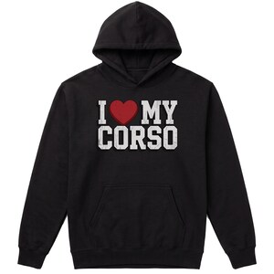 May include: A black hooded sweatshirt featuring a graphic on the chest with the text I, a red heart symbol, and the word MY CORSO in white block letters. The hoodie includes a front kangaroo pocket, long sleeves, and a drawstring-free hood.