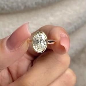 2 Carat Oval Moissanite Engagement Ring: 14k Yellow Gold Bezel Solitaire
