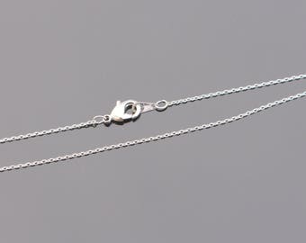 May include: A silver chain necklace with a lobster clasp closure.