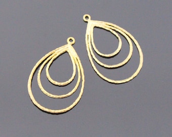 May include: Two gold-toned metal jewelry charms, each featuring a nested teardrop design. The charms consist of three concentric, textured teardrop-shaped wire frames connected at the top by a small circular jump ring loop for attachment.