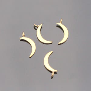 May include: Four gold crescent moon charms with a loop for attaching to jewelry or other crafts.