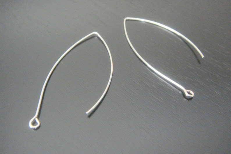May include: Two silver earring hooks with a loop at one end and a small loop at the other end.