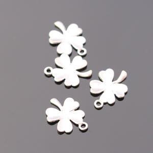 May include: Five silver-toned four-leaf clover charms with a white enamel finish. The charms have a loop at the top for attaching to jewelry or other crafts.