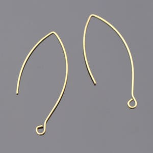 May include: Two gold-colored earring wires with a loop at the end. The wires are bent into a teardrop shape.