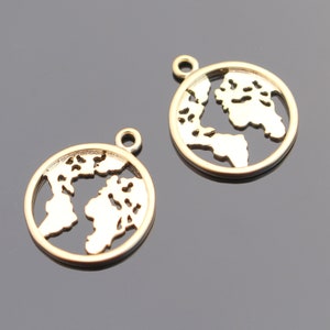 May include: Two gold-colored metal charms shaped like the world. Each charm has a cutout design of the continents.