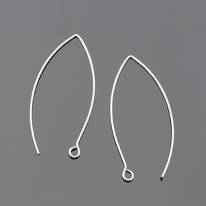 May include: Two silver wire earring hoops with a small loop at the bottom.